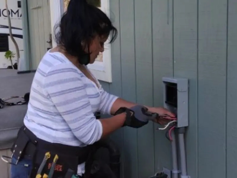 Licensed electrician wiring an exterior subpanel in Pepperell